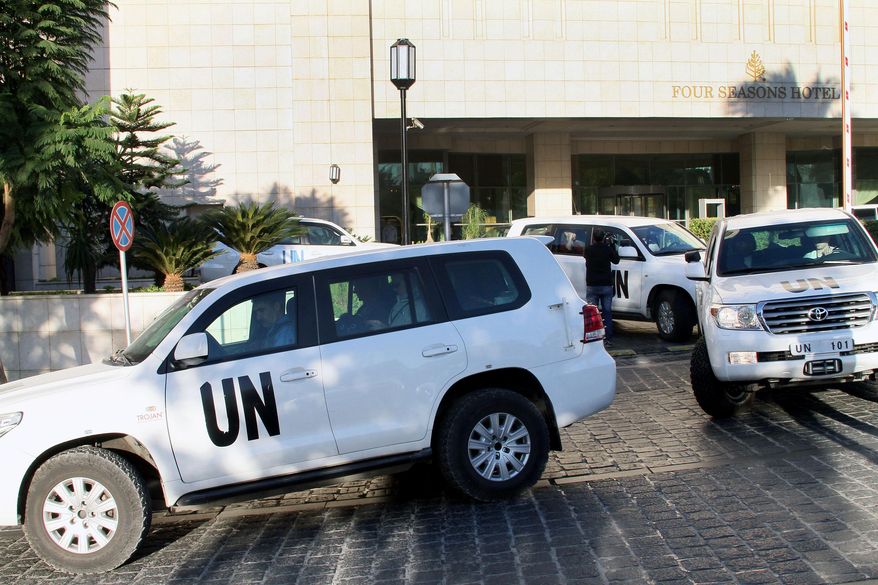FILE - In this Oct. 8, 2013 file photo, a convoy of chemical weapons disarmament experts depart the Four Seasons Hotel in Damascus, Syria. Two years after President Bashar Assad agreed to destroy his chemical arsenal and joined the Chemical Weapons Convention, activists said they have documented 18 cases of chlorine gas used in the country's rebel-held north since March 6, 2015, when the U.N. issued a resolution determining that chlorine was used in Syria and warning of repercussions. (AP Photo, File)