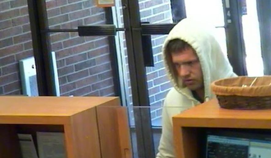 This image made from surveillance video released by the Camden County Prosecutor's Office shows a bank robbery suspect at a PNC Bank in Gloucester Township, N.J. on Saturday morning, May 23, 2015. The prosecutor's office says he passed a note demanding money to a teller, received an unspecified amount of cash and then left on foot. Officials said no weapon was displayed and the note did not say if he was armed. (Camden County Prosecutor's Office via AP)