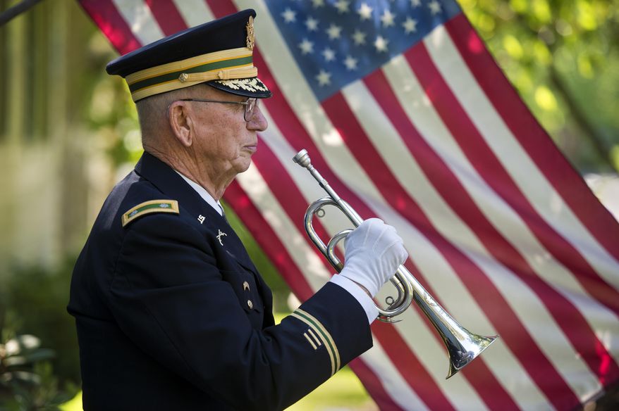 This May 21, 2015 photo shows Ltc. USAR (Ret) Phil Kowzan of Spokane, Wash. Since 2001, he has played taps at 1,259 military honor funerals in the Spokane-area. And his service is in increasingly high demand. Kowzan, 77, knows of only three other bugler players and it's not unusual for him to play for three funerals in the morning, and another three in the afternoon. "I did seven one day," he says. "That's a lot." (Dan Pelle/The Spokesman-Review via AP)