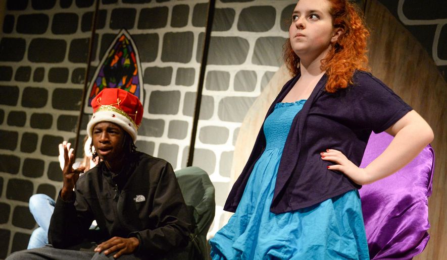 In this May 20, 2015 photo, Bondurant Middle School eighth-graders Malachi Quarles and Julia Martinez rehearse a scene in "The Medieval Whodunit" at the school in Frankfort, Ky. A group of five Western Hills High School sophomores, calling themselves Teenagers for Theatre, have been at BMS after school for the past several weeks helping a group of 20-25 sixth-, seventh- and eighth-graders produce the play “The Medieval Whodunit,” the sophomores wrote when they were in seventh-grade. (Hannah Brown/The State Journal via AP)