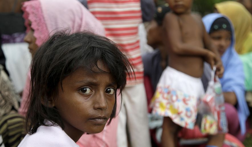 Ethnic Rohingya gather before receiving medical treatments at temporary shelter in Langsa, Aceh province, Indonesia, Friday, May 22, 2015. Thousands of refugees and migrants have washed ashore in Malaysia, Indonesia and Thailand, about half Rohingya and the rest from Bangladesh, according to the International Organization for Migration. The U.N. refugee agency estimates more than 3,000 others may still be at sea.(AP Photo/Tatan Syuflana)