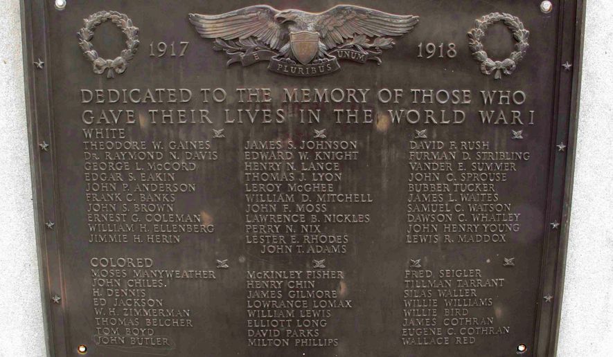 FILE - This photo taken Jan. 22, 2015 shows a plaque honoring World War I soldiers on Greenwood County memorial. The former governor who helped push to have the Confederate flag removed from atop the South Carolina Statehouse dome has some advice for people in Greenwood who want to change the plaques on a war memorial that separates fallen soldiers by race but can't without a two-thirds vote of the Legislature because of one tenent of the compromise. "No one is going to challenge them if they just go ahead and do it," said Jim Hodges. (AP Photo/Jeffrey Collins)