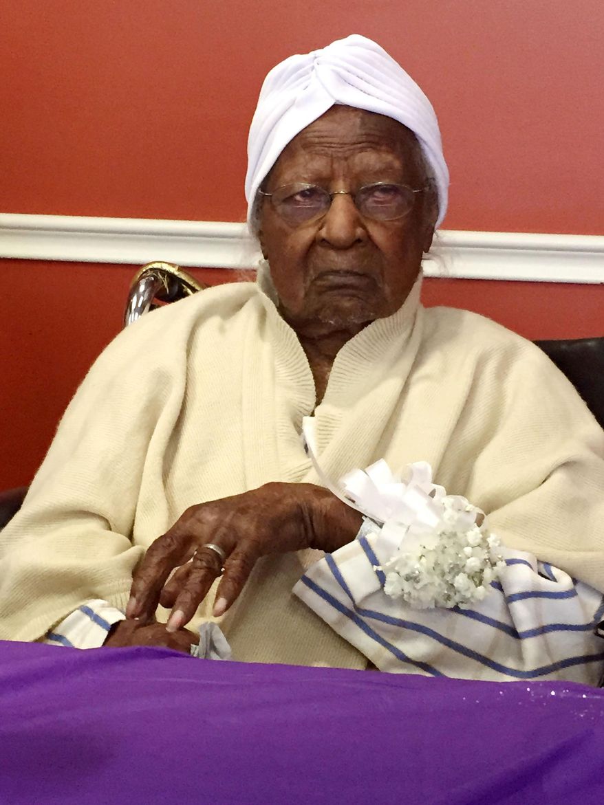 In this Thursday, May 21, 2015 photo, Jeralean Talley, born on May 23, 1899, is honored at the Inkster, Mich. district office of the Michigan Department of Health and Human Services. On Saturday, May 23, 2015, she plans to celebrate her 116th birthday. Talley bowled until she was 104 and still likes to catch fish. (Elisha Anderson/Detroit Free Press via AP)