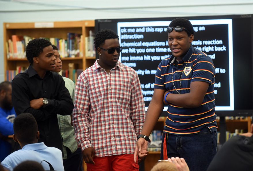Dalewood Middle students Tahj Cargle, Jamaal Ward, Eric Kelly and Jamicheal Wilson, from left, perform a science rap song for 7th graders Wednesday, May 20, 2015, at the school.  The four Dalewood Middle School students comprise the rap group Re-Generation, and on May 20 they were performing for the seventh-grade students at their end-of-the-year awards ceremony in the school&#39;s media center. The group has gained some fame of late, appearing on local radio and winning a regional competition at Chattanooga State Community College. (Angela Lewis Foster/Chattanooga Times Free Press via AP)