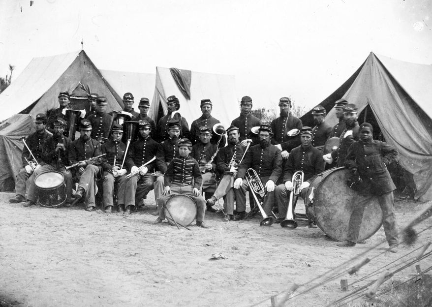 In this photo provided by the New Hampshire Historical Society the Third New Hampshire Regiment Band is seen in this 1800’s photo taken by H.P. Moore. Music written for one of the best bands to serve in the Union Army during the Civil War is returning to its roots with a series of free Memorial Day weekend concerts. The Wildcat Regiment Band, which uses Civil War-era instruments, performs regularly for the National Park Service at historic Civil War battlegrounds. (H.P. Moore/New Hampshire Historical Society via AP)