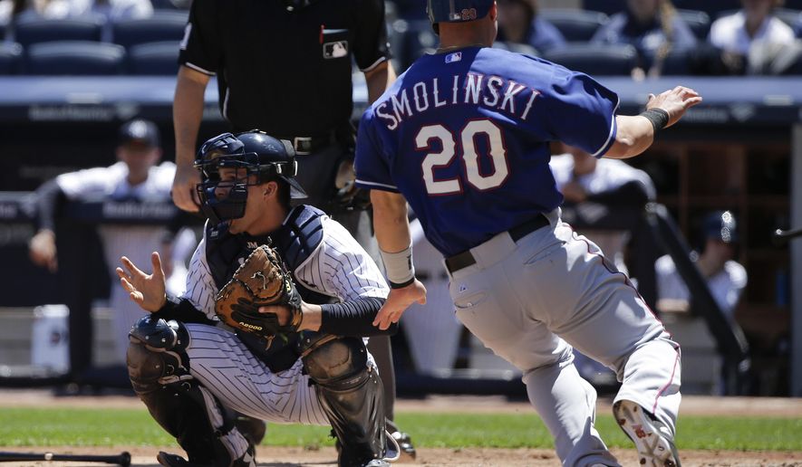 New York Yankees catcher John Ryan Murphy waits for the throw home as Texas Rangers left fielder Jake Smolinski (20) scores on a base hit by Shin-Soo Choo (17) during the third inning of a baseball game, Saturday, May 23, 2015, in New York. (AP Photo/Julie Jacobson)