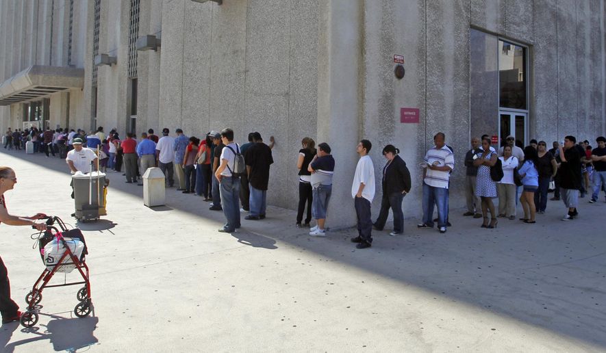 FILE - In this March 18, 2010 file photo, people line up outside the Metropolitan Courthouse, which handles traffic citations and other matters, in downtown Los Angeles. Gov. Jerry Brown is proposing an amnesty program for Californians who can’t afford to pay off spiraling traffic fines and court fees that have led to millions of driver’s licenses being suspended. (AP Photo/Damian Dovarganes, File)