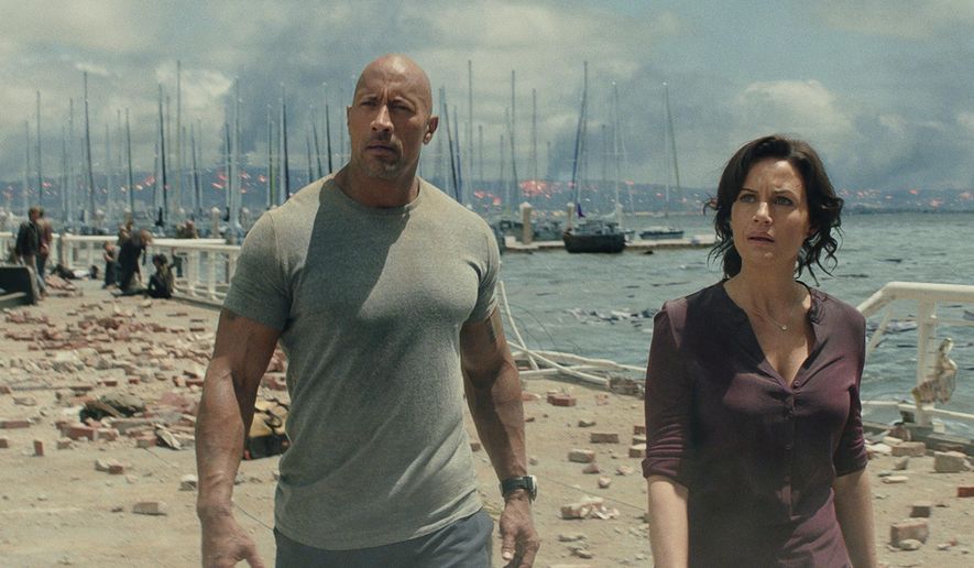 This photo provided by Warner Bros. Pictures shows Dwayne Johnson, left, as Ray, and Carla Gugino as Emma, in a scene from the action thriller, "San Andreas." The movie releases in theaters on May 29, 2015. (Courtesy Warner Bros. Pictures via AP)