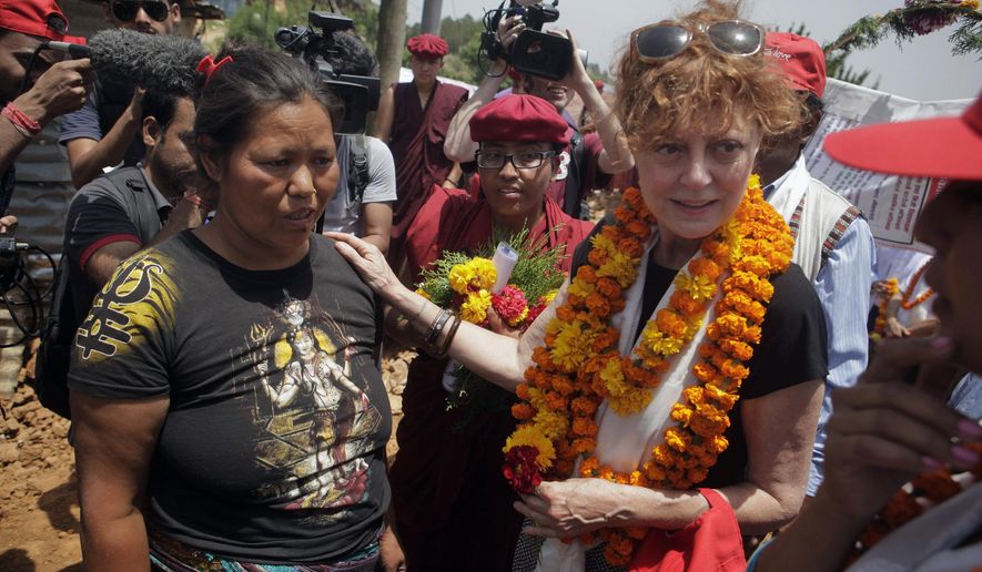 Oscar-winning Hollywood actress Susan Sarandon, right, comforts Kanti Maya Tamang, who lost her husband and daughter in the April 25 earthquake, at Ramkot village on the outskirts of Kathmandu, Nepal, Sunday, May 24, 2015. Sarandon is in Nepal for five days, urging tourists to come to the Himalayan nation where two powerful earthquakes have killed thousands of people and made several hundreds of thousands homeless. (AP Photo/Niranjan Shrestha)