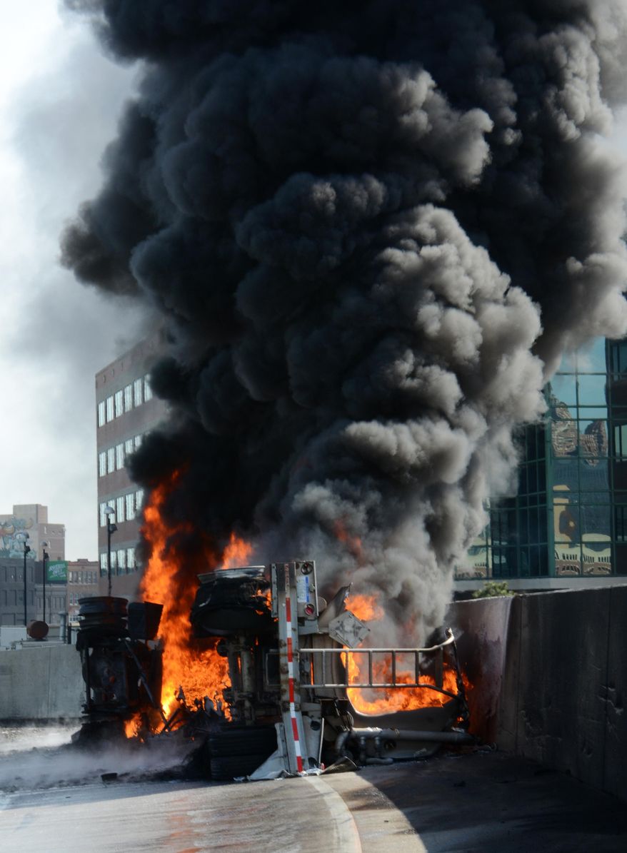 A tanker truck that was carrying 9,000 gallons of unleaded fuel burns after it exploded and caught fire on Interstate 75 in downtown Detroit Sunday, May 24, 2015. The driver wasn't hurt, but Interstate 375 at I-75 remained shut down as well as north I-75 in the area. (AP Photo/Bill Eisner)