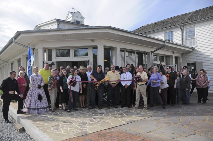 ADVANCE FOR MONDAY MAY 24 AND THEREAFTER - In a Thursday May 14, 2015 photo, Individuals instrumental in the construction of the Beverly Heritage Center stand alongside members of the Elkins-Randolph County Chamber of Commerce and state and county officials during a ribbon cutting commemorating the completion of the museum in Beverly, W. Va. After more than 12 years, construction is complete at a local museum dedicated to the preservation of regional culture and history. (Chris Lee/The Inter-Mountain via AP)