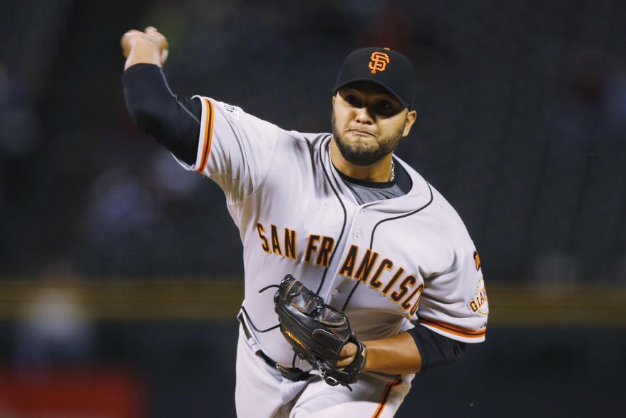 San Francisco Giants starting pitcher Yusmeiro Petit works against the Colorado Rockies in the first inning of Game 2 of a baseball doubleheader Saturday, May 23, 2015, in Denver. (AP Photo/David Zalubowski)
