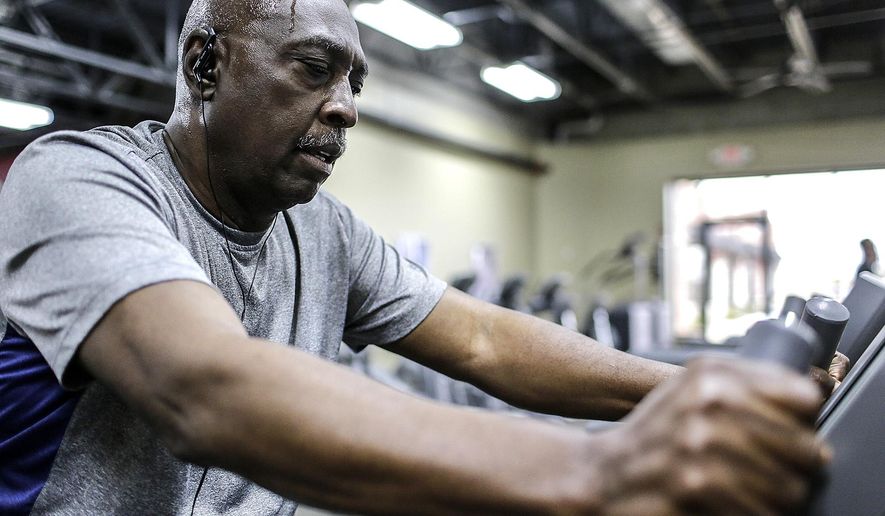 In this photo taken April 17, 2015, Ret. U.S. Army Command Sergeant Major Fred Jamison, in Plainfield, Ill., works out in Joliet, Ill. Jamison is part of Healthy Minds Healthy Bodies which helps veterans get fitness training. Healthy Minds Healthy Bodies is part of the nonprofit veterans’ organization AllenForce, founded by Donna Allen-Sebok, a therapeutic recreation specialist. She thought of the program after someone asked her to help an injured veteran. (Lathan Goumas/Herald-News via AP) MANDATORY CREDIT; CHICAGO TRIBUNE OUT