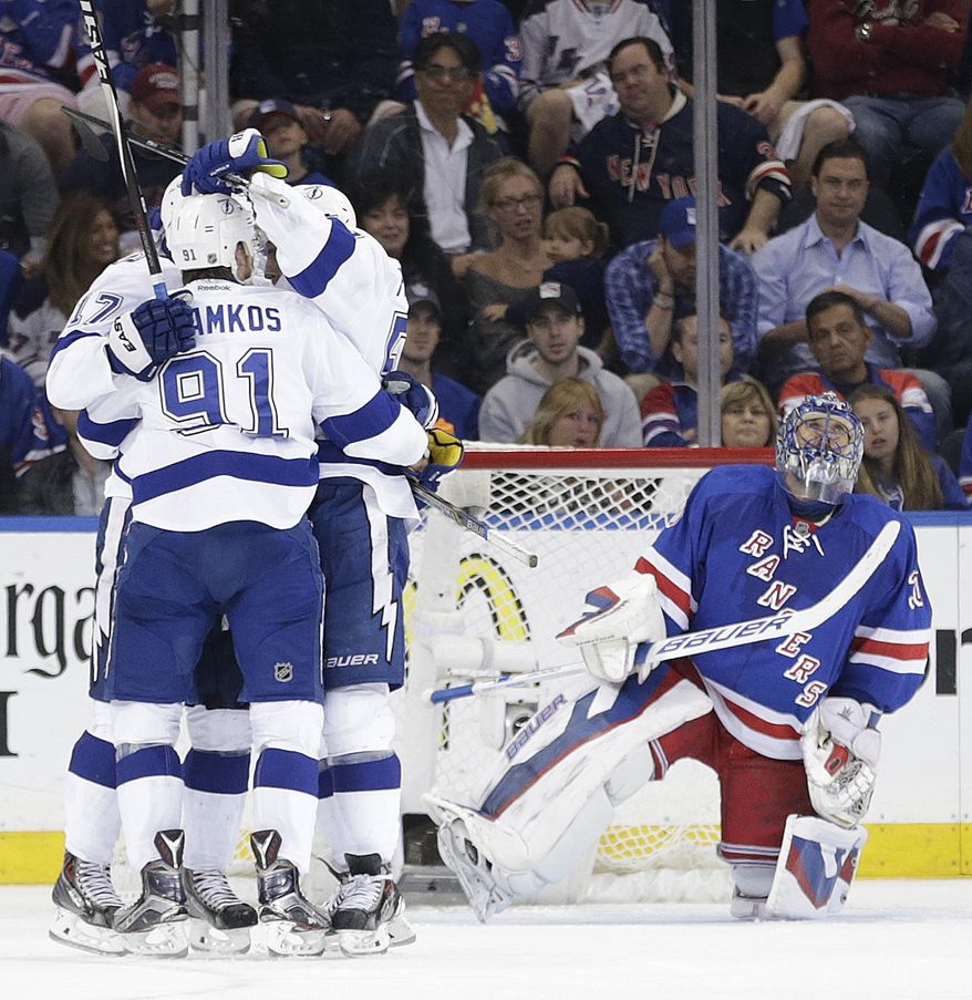 New York Rangers goalie Henrik Lundqvist (30) checks the scoreboard as the Tampa Bay Lightning celebrate a second period goal during Game 5 of the Eastern Conference final during the NHL hockey Stanley Cup playoffs, Sunday, May 24, 2015, in New York. (AP Photo/Frank Franklin)