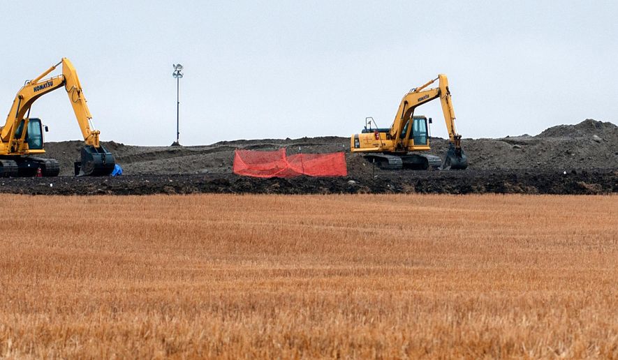 FILE - This Oct. 11, 2013 file photo shows cleanup at the site of an oil pipeline leak and spill near Tioga, N.D. The state Health Department says cleanup of a pipeline rupture that caused more than 20,000 barrels of crude to ooze across a northwestern North Dakota wheat field will take twice as long as the company had expected. The massive spill from a Tesoro Corp. pipeline that was discovered by a Tioga farmer in September 2013. The spill has been called the worst in state history. (AP Photo/Kevin Cederstrom, File)