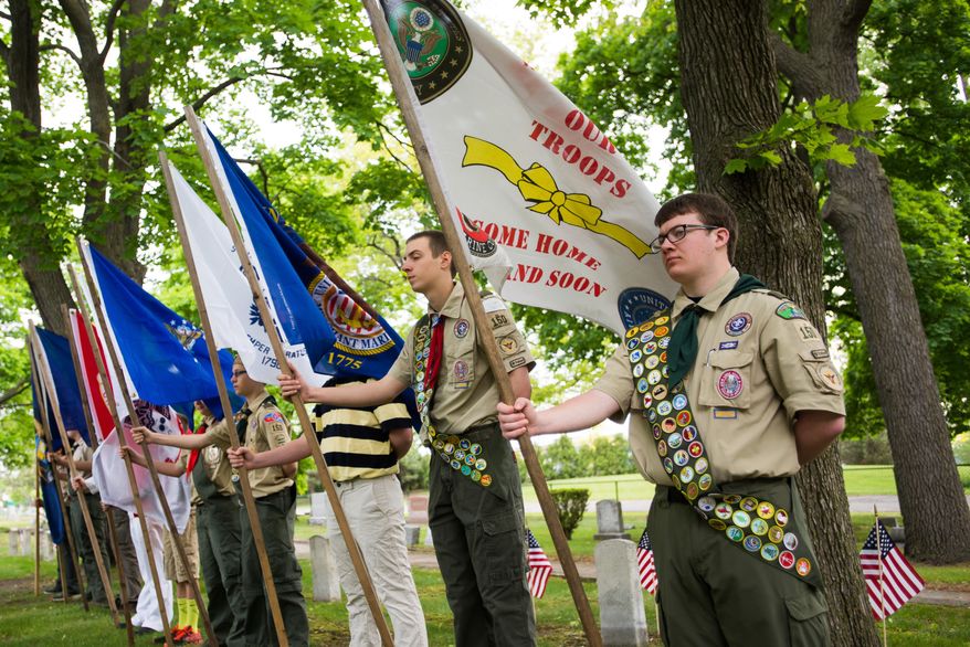 In this file photo, attendees of Boy Scouts of America stand in a line for the opening flag ceremony, Monday, May 25, 2015, at Oak Ridge Cemetery, in Bay City, Mich. (Amanda Ray/The Bay City Times via AP) **FILE**