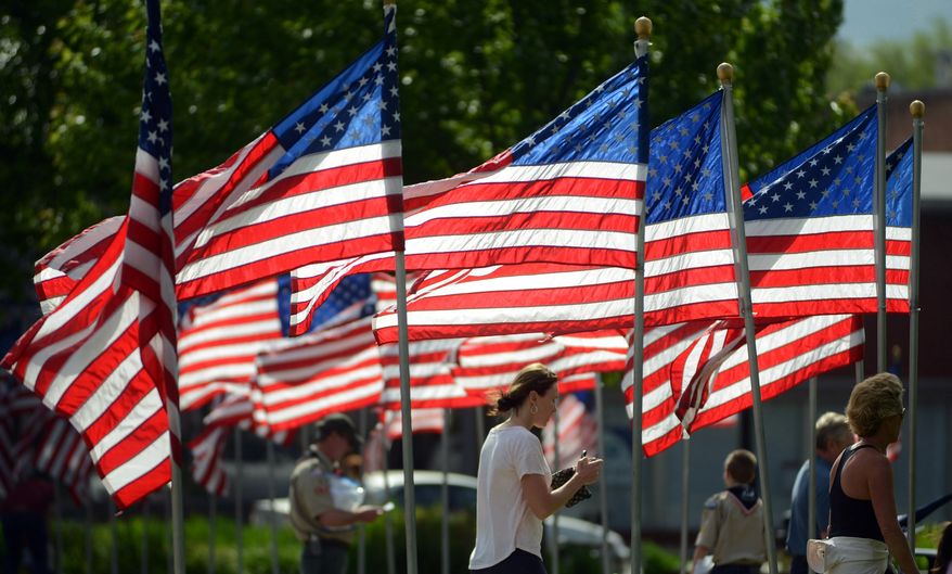 American flags surround Cook Park in downtown Libertyville, Ill., for Memorial Day, Monday, May 25, 2015. Memorial Day is a day of remembrance for those who have died in service of the United States. (Paul Valade/Daily Herald via AP)