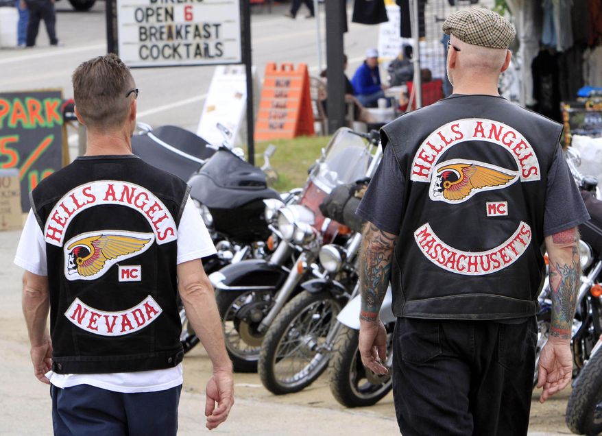 FILE - In this June 17, 2011, file photo, members of the Hells Angels walk along the strip at Weirs Beach during Bike Week in Laconia, N.H. New Hampshire's annual Bike Week is in June 2015, just weeks after the fatal Waco, Texas, biker gangs shootout. New Hampshire organizers are working on security concerns and what they might do differently running up to the event that attracts thousands of bikers. (AP Photo/Jim Cole, File)