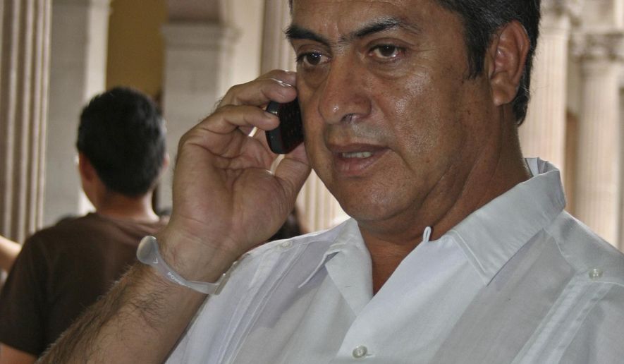 FILE - In this March 30, 2011 file photo, Jaime Rodriguez, mayor of the Mexican town Villa Garcia, speaks on a cellphone in Monterrey, Mexico, a day after he survived an assassination attempt. As mayor of a suburb of the northern industrial city of Monterrey, Rodriguez survived two assassination attempts that left his car bullet-ridden, defying, he says, the fierce Zetas cartel. Now he is trying to beat the odds in another way, running as an independent for governor of Nuevo Leon, a wealthy and strategic state bordering Texas. (AP Photo, File)