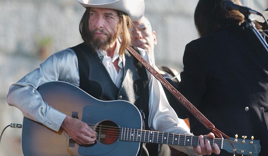 FILE - In this Aug. 3, 2002 file photo, legendary singer-songwriter Bob Dylan performs at the Newport Folk Festival in R.I. Dylan made rock history when he went electric at the Newport Folk Festival in 1965. This year's festival will pay tribute to the legendary moment with a secret lineup of musicians billed as "'65 Revisited." Festival producer Jay Sweet on Tuesday, May 26, 2015, calls it an "all-star lineup" of nearly a dozen contemporary artists celebrating Dylan's performance. (AP Photo/Michael Dwyer, File)