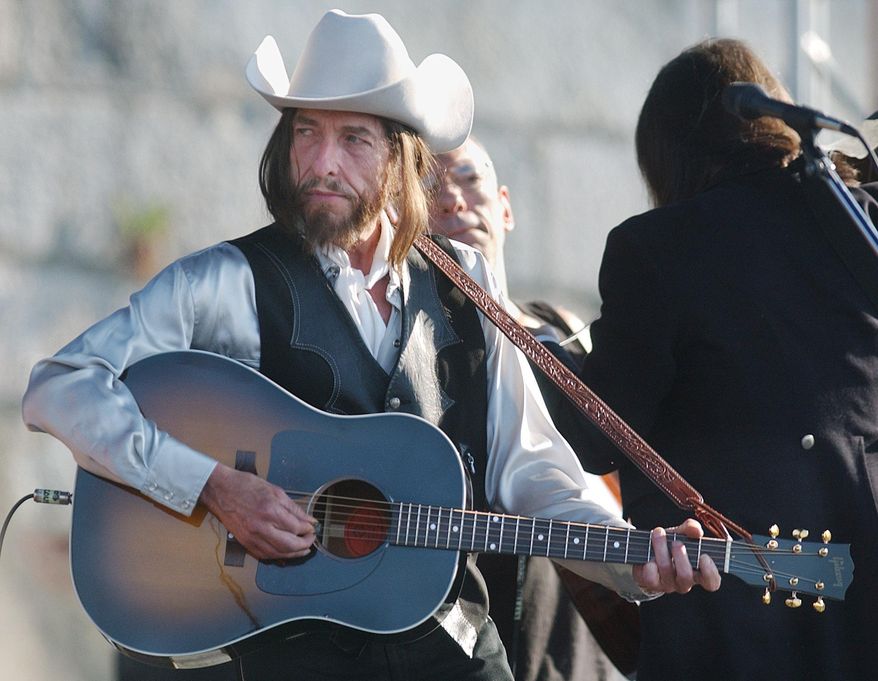 FILE - In this Aug. 3, 2002 file photo, legendary singer-songwriter Bob Dylan performs at the Newport Folk Festival in R.I. Dylan made rock history when he went electric at the Newport Folk Festival in 1965. This year's festival will pay tribute to the legendary moment with a secret lineup of musicians billed as "'65 Revisited." Festival producer Jay Sweet on Tuesday, May 26, 2015, calls it an "all-star lineup" of nearly a dozen contemporary artists celebrating Dylan's performance. (AP Photo/Michael Dwyer, File)