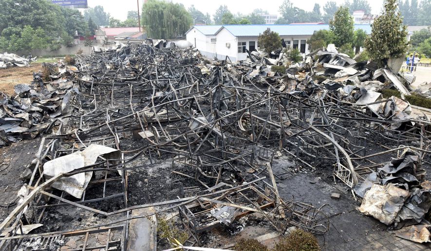 This photo released by China's Xinhua News Agency shows a fire-gutted rest home in Pingdingshan, central China's Henan Province Tuesday, May 26, 2015. A fire swept through the rest home in central China, killing more than 35 people and injuring several, Chinese authorities said Tuesday. The fire broke out Monday night in an apartment building being used as a privately run rest home in the city of Pingdingshan in Henan province, according to a statement from the province's work safety administration. (Zhao Peng/Xinhua via AP) NO SALES