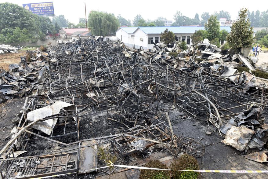 This photo released by China's Xinhua News Agency shows a fire-gutted rest home in Pingdingshan, central China's Henan Province Tuesday, May 26, 2015. A fire swept through the rest home in central China, killing more than 35 people and injuring several, Chinese authorities said Tuesday. The fire broke out Monday night in an apartment building being used as a privately run rest home in the city of Pingdingshan in Henan province, according to a statement from the province's work safety administration. (Zhao Peng/Xinhua via AP) NO SALES