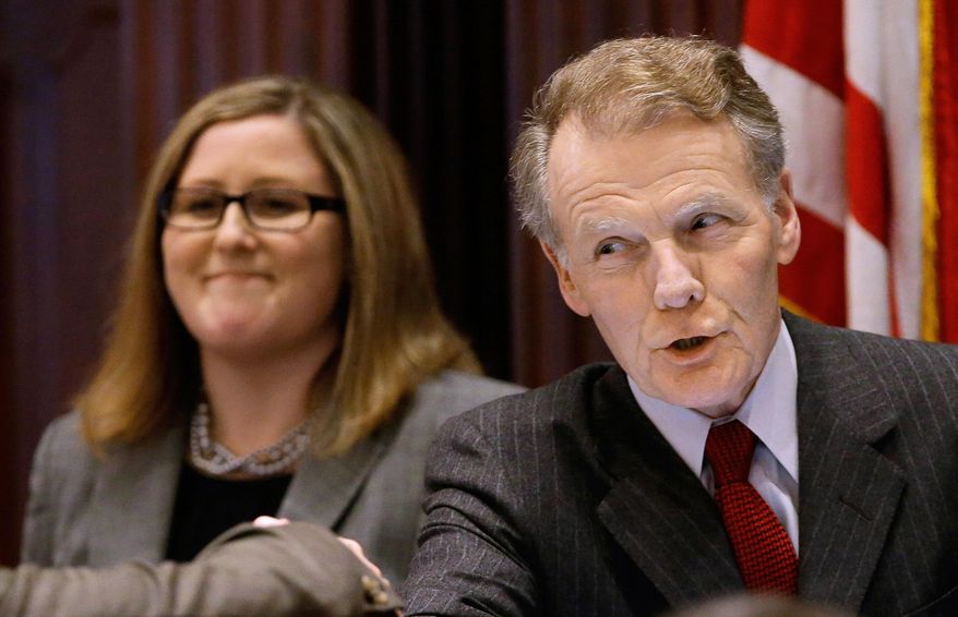 In a Feb. 18, 2015 file photo, Illinois Speaker of the House Michael Madigan, D-Chicago, right, speaks to Illinois Gov. Bruce Rauner in the House chambers, at the state capitol in Springfield Ill. Pieces of Illinois Democrats' proposed state budget are coming into focus Tuesday, May 26, 2015, as lawmakers begin advancing them in the Legislature ahead of a scheduled Sunday adjournment. (AP Photo/Seth Perlman,File)
