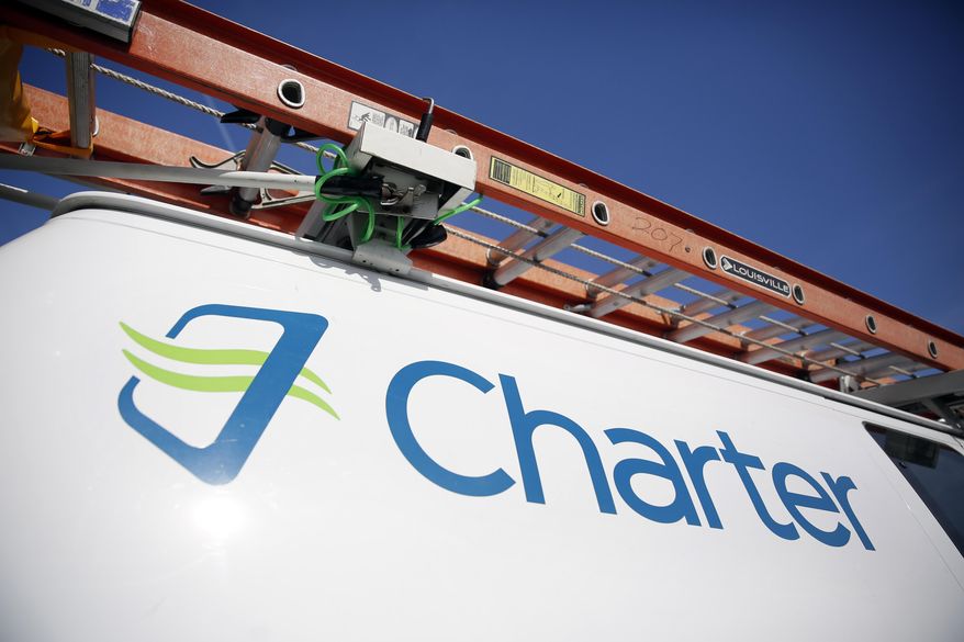 This April 1, 2015 photo shows a Charter Communications van in St. (AP Photo/Jeff Roberson)