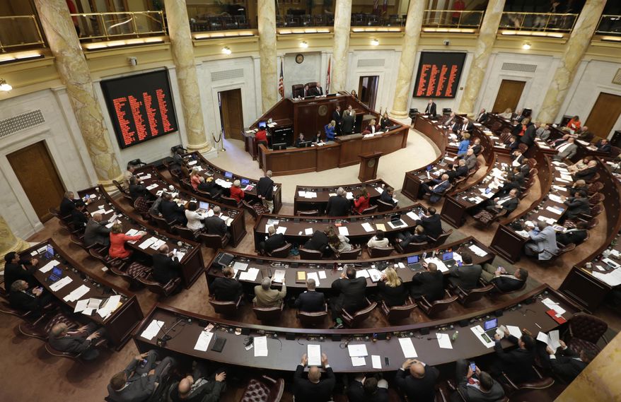State representatives gather in the House chamber at the state Capitol in Little Rock, Ark., Tuesday, May 26, 2015. Arkansas lawmakers have begun a special legislative session focusing on an $87 million incentive package aimed at helping Lockheed Martin land a major defense contract. (AP Photo/Danny Johnston)
