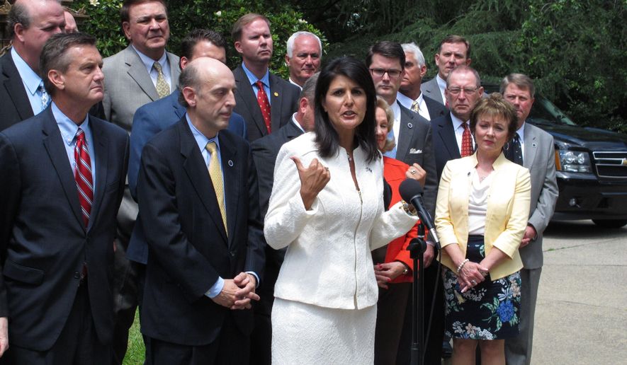 South Carolina Gov. Nikki Haley surrounds herself with Republican lawmakers as she talks about what she would like to do with $400 million in extra revenue the state is expected to get at a news conference on Tuesday, May 26, 2015, in Columbia, S.C. Haley said the Legislature needs to give a tax cut, pay off debt or fix the state's roads and bridges with the extra revenue. (AP Photo/Jeffrey Collins)