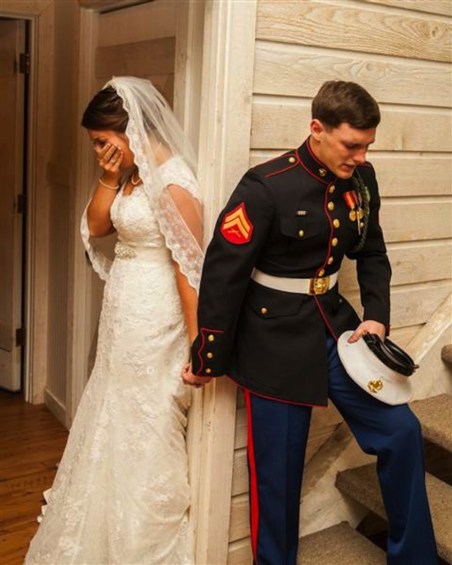 A photo U.S. Marine Cpl. Caleb Earwood holding his bride-to-be&#39;s hand in prayer has gone viral after it was posted online by the wedding photographer. (Dwayne Schmidt Photography via ABC News)