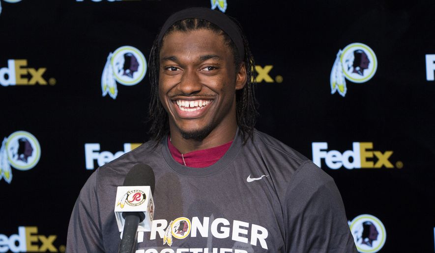 Washington Redskins quarterback Robert Griffin III smiles during a news conference after an NFL football organized team activity at Redskins Park, on Tuesday, May 26, 2015, in Ashburn, Va. (AP Photo/Evan Vucci)