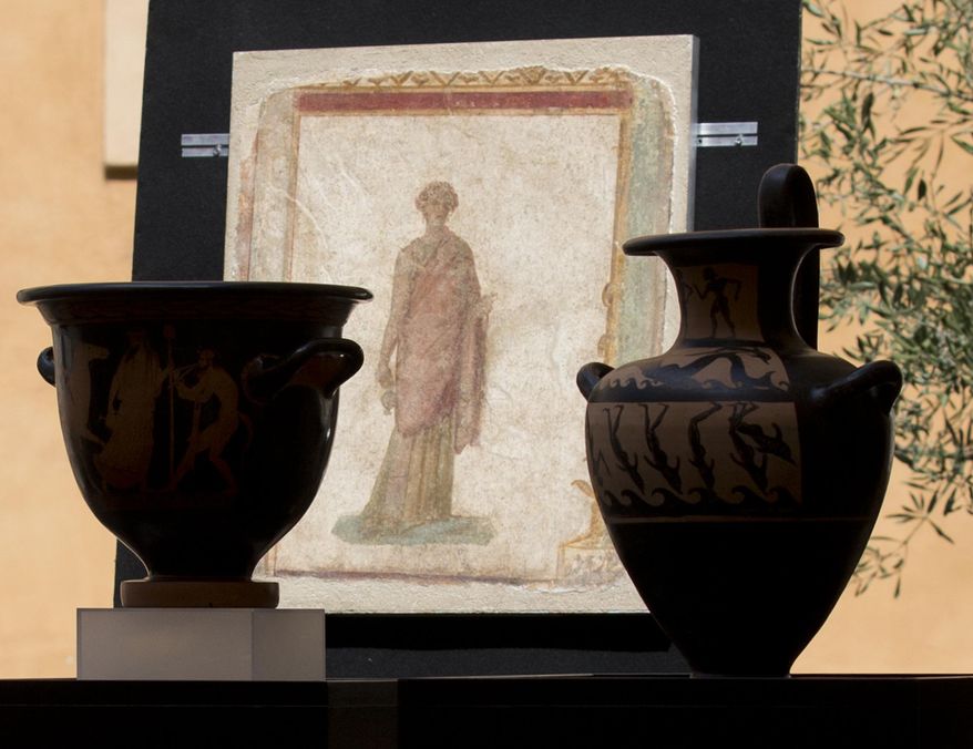 A first century B.C. fresco taken from Pompeii is displayed during a press conference in Rome, Tuesday, May 26, 2015. The United States has returned 25 artifacts that were looted from Italy, including Etruscan vases, 1st century frescoes and precious books that had made their way into top-notch U.S. museum, university and private collections. (AP Photo/Alessandra Tarantino)