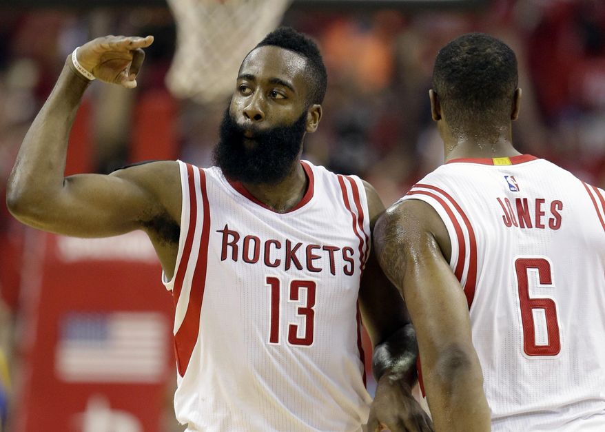 Houston Rockets guard James Harden (13) celebrates with forward Terrence Jones (6) after a 3-point basket against the Golden State Warriors during the first half in Game 4 of the NBA basketball Western Conference finals Monday, May 25, 2015, in Houston. (AP Photo/David J. Phillip)