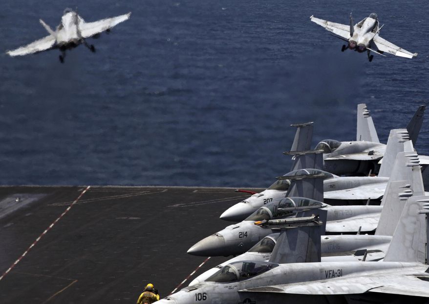 In this Monday, Aug. 11, 2014m file photo, F/A-18 fighter jets take off for a mission in Iraq from the flight deck of the U.S. Navy aircraft carrier USS George H.W. Bush in the Persian Gulf. The U.S.-led coalition has carried out over 4,100 airstrikes against Islamic State radicals, with limited results. (AP Photo/Hasan Jamali, File)