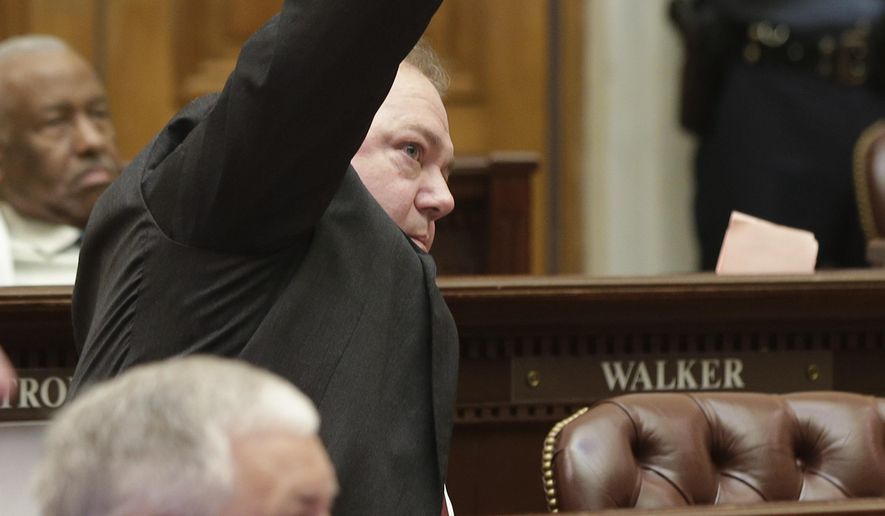 Rep. David Whitaker, D-Fayetteville, center, signals his intention to speak against a bill that chafes Arkansas primary election dates in the House chamber at the Arkansas state Capitol in Little Rock, Ark., Wednesday, May 27, 2015. The bill passed. (AP Photo/Danny Johnston)