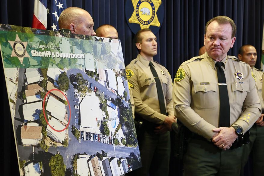 Los Angeles Sheriff Jim McDonnell, right, speaks during a news conference in Monterey Park, Calif., Tuesday, May 26, 2015. Los Angeles County sheriff's officials say deputies endured great personal risk to avoid killing an armed 74-year-old woman during a 22-hour standoff near Woodland Hills last week that ended happily. (AP Photo/Nick Ut)
