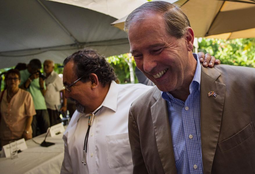 U.S. Senator Tom Udall, right, walks with U.S. senator Raul Grijalba, left, after a press conference in Havana, Cuba, Wednesday, May 27, 2015. Udall, a New Mexico Democrat who led a four-member Democratic congressional delegation to Cuba, all supporters of lifting the embargo on Cuba, said there appears to be growing momentum to removing at least elements of it, such as the ban on travel. (AP Photo/Ramon Espinosa)