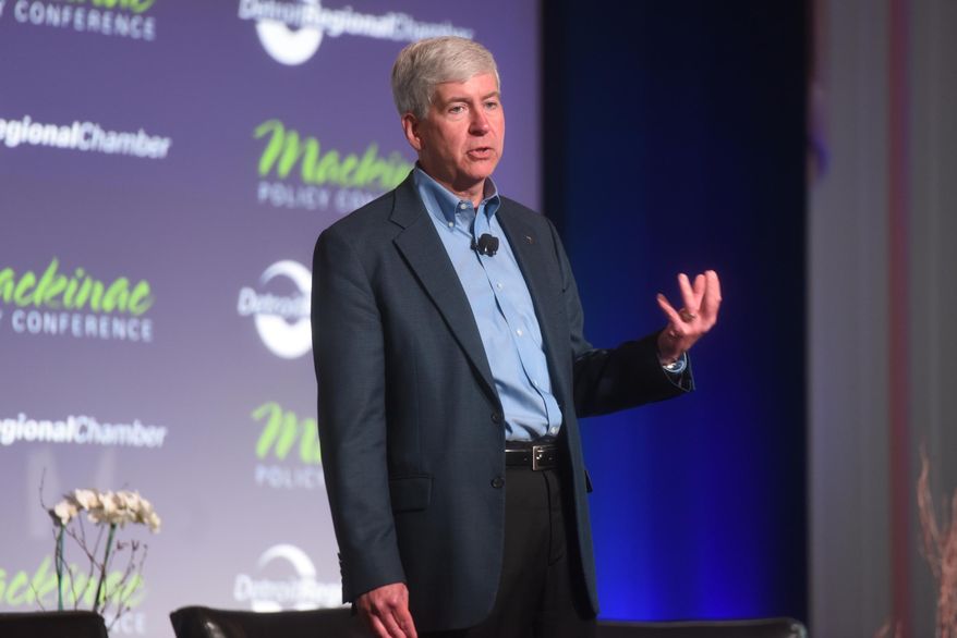 Gov. Rick Snyder speaks at the opening session of the Mackinac Policy Conference Wednesday May 27, 2015,on Mackinac Island, Mich. Prominent Detroit-area business and community leaders say the Republican-led Legislature has no excuse to ignore Detroit Public School's debt because the state ultimately is constitutionally responsible for it. (Tanya Moutzalias/The Ann Arbor News via AP) LOCAL TELEVISION OUT; LOCAL INTERNET OUT