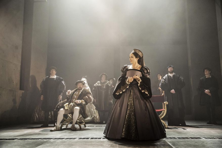 This photo provided by Jeffrey Richards Associates shows, from left, Ben Miles (standing) as William Cromwell, Nathaniel Parker (seated) as Henry VIII and Lydia Leonard as Anne Boleyn, in a scene from The Shakespeare Company production of Mantel's "Wolf Hall," directed by Jeremy Herinn. (Johan Persson/Jeffrey Richards Associates via AP)