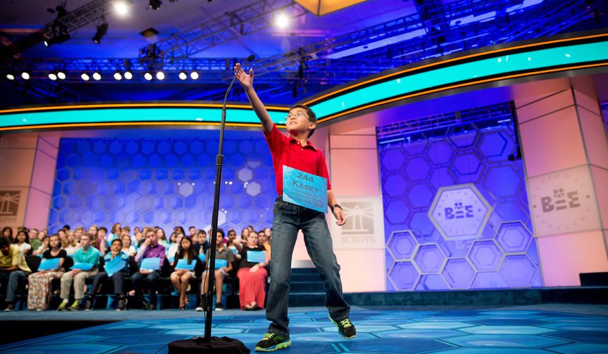 Kasey Torres, 10, of San Angelo, Texas, reaches up for the microphone as he takes the stage during 2015 Scripps National Spelling Bee, Wednesday, May 27, 2015, in Oxon Hill, Md. (AP Photo/Andrew Harnik)