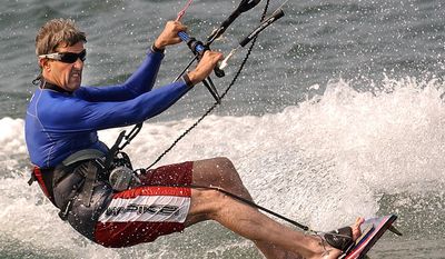 John Kerry, D-Mass., kite surfs, which is surfing on a foot board while being pulled by a small parachute, in Nantucket Harbor in Nantucket, Mass., July 20, 2004.