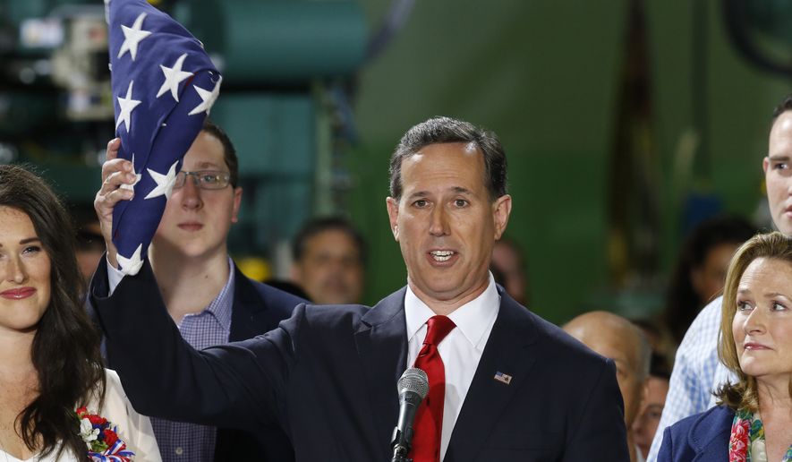 Former U.S. Sen. Rick Santorum holds an American flag as he gives his speech announcing his candidacy for the Republican nomination for President of the United States in the 2016 election on Wednesday, May 27, 2015 in Cabot, Pa. (AP Photo/Keith Srakocic)
