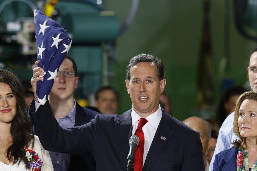 Former U.S. Sen. Rick Santorum holds an American flag as he gives his speech announcing his candidacy for the Republican nomination for President of the United States in the 2016 election on Wednesday, May 27, 2015 in Cabot, Pa. (AP Photo/Keith Srakocic)