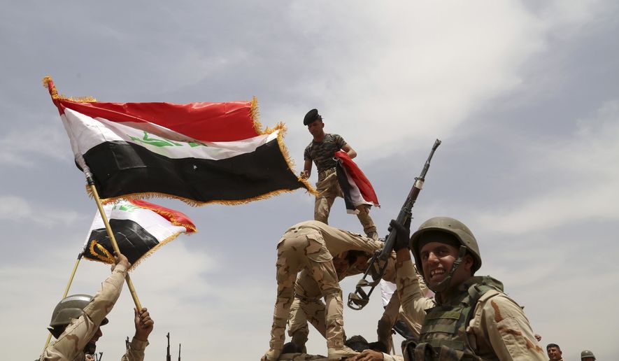 Iraqi army soldiers celebrate during a training mission outside Baghdad, Iraq, Wednesday, May 27, 2015. Islamic State extremists unleashed a wave of suicide attacks targeting the Iraqi army in western Anbar province, killing at least 17 troops in a major blow to government efforts to dislodge the militants from the sprawling Sunni heartland, an Iraqi military spokesman said Wednesday. (AP Photo/Khalid Mohammed)