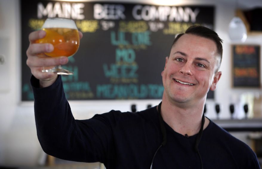 In this May 7, 2015 photo, Dan Kleban, a co-owner of the Maine Beer Company, poses in the company's tasting room in Freeport, Maine. Maine Beer Co. has grown over six years from a one-barrel nanobrewery to producing more than 9,000 barrels this year. (AP Photo/Robert F. Bukaty)