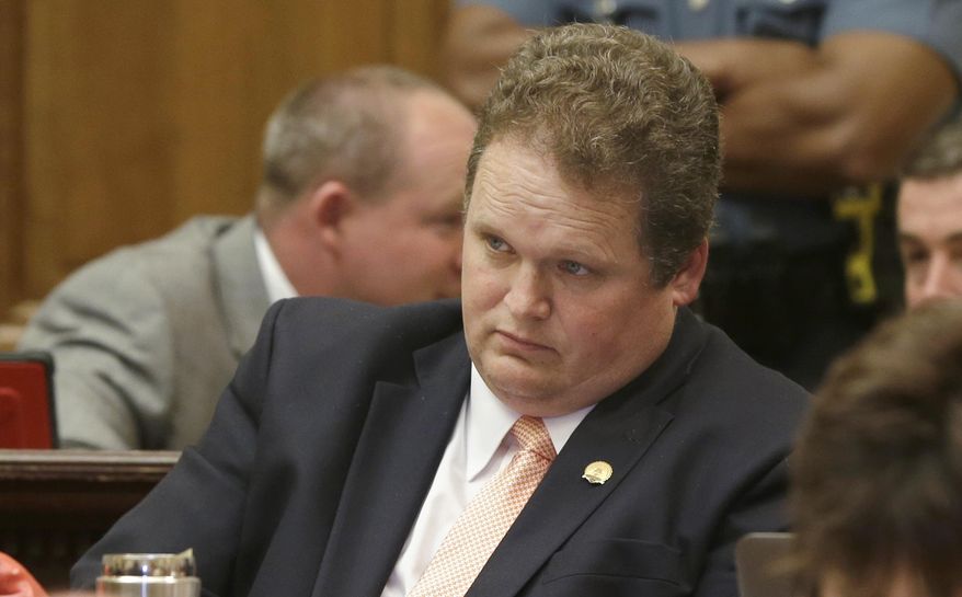 Rep. Nate Bell, R-Mena, listens to discussion on a bill in the House chamber at the Arkansas state Capitol in Little Rock, Ark., that proposes to change the dates of primary elections inn the state Wednesday, May 27, 2015. The bill, opposed by Bell, passed in the House. (AP Photo/Danny Johnston)