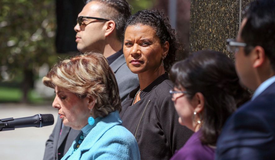Lise-Lotte Lublin, center, listens to attorney Gloria Allred speak at a news conference in front of the Legislative Building in Carson City, Nev., Tuesday, May 26, 2015. Nevada Gov. Brian Sandoval has approved a bill extending Nevada's statute of limitations on sexual assault cases so victims have more time to report their experience and pursue criminal charges. The bill raises the reporting deadline on sex assaults from four years to 20 years after the date of the alleged crime. (AP Photo/Cathleen Allison)