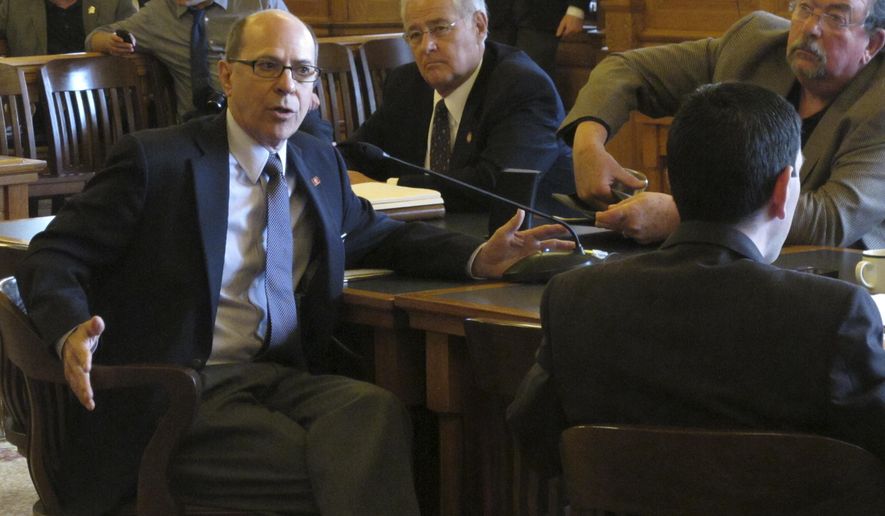 Kansas state Rep. Steve Brunk, R-Wichita, left, makes a point about tax issues during a meeting of House Republicans, Thursday May 28, 2015, at the Statehouse in Topeka, Kan. Brunk and other GOP conservatives fear losing influence over tax policy when House and Senate negotiators begin work on the final version of a bill to raise taxes. (AP Photo/John Hanna)